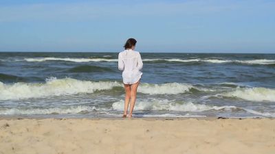 Girl At The Beach Walking Through Sea Water